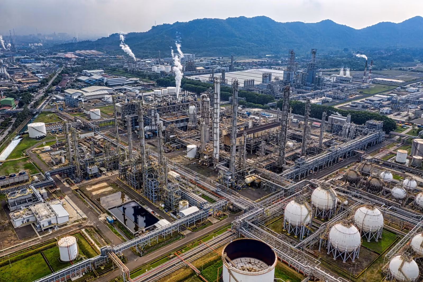 Illustrative aerial view of refinery structures and storage tanks